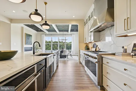 a kitchen with sink stove and cabinets