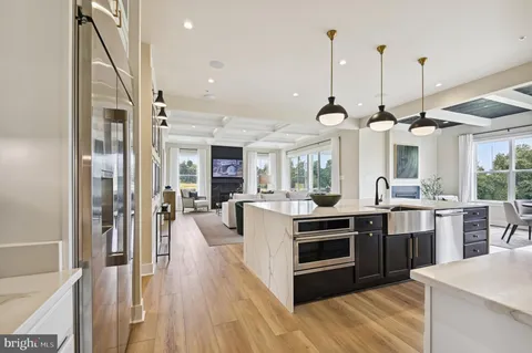 a kitchen with stainless steel appliances granite countertop a stove and a chandelier