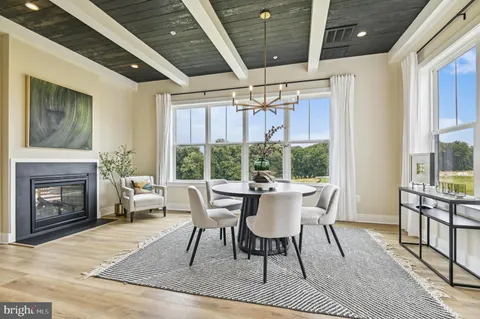 a dining room with furniture window and wooden floor