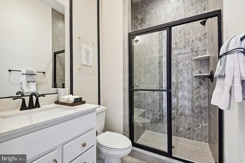 a bathroom with a double vanity sink toilet and shower