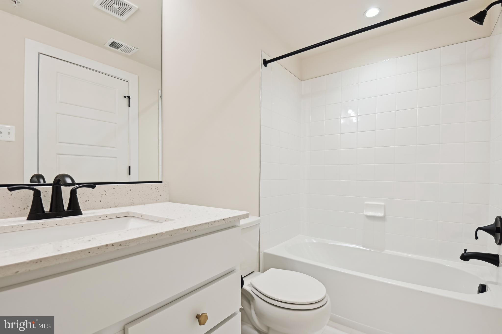 6112 Clarks Lane Baltimore, MD 21209 - Photo 32 of 40 a bathroom with a sink a toilet and a bathtub