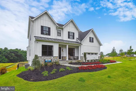 a front view of house with yard and outdoor seating