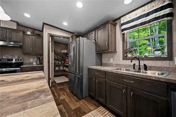 a kitchen with a sink stainless steel appliances and cabinets