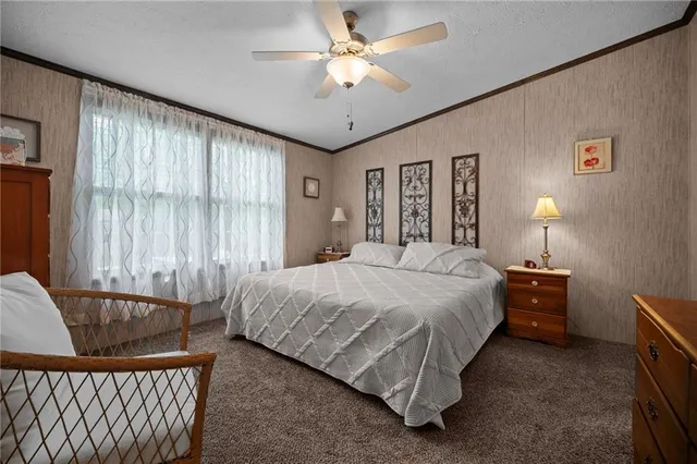 a spacious bedroom with a bed and a chandelier