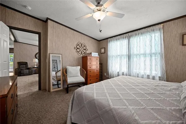 a bedroom with a large bed and a chandelier