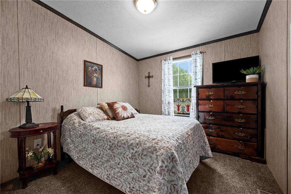 73 South Summit Road, Unit 510 Greenville, PA 16125 - Photo 21 of 33 a bedroom with a bed and a flat tv screen