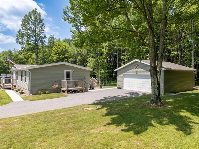 a view of a house with backyard and sitting area