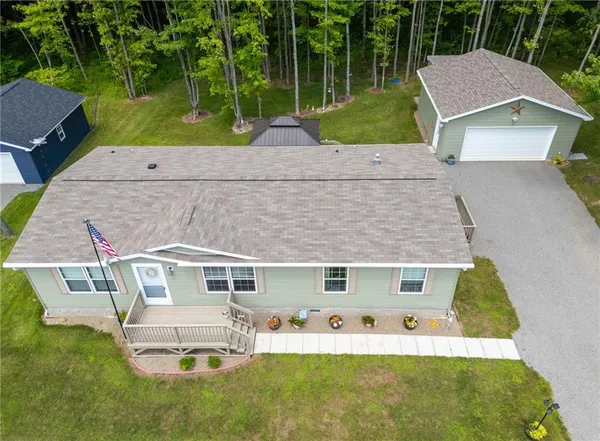 an aerial view of a house with a yard