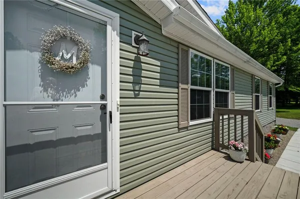 a view of a house with a door and wooden floor