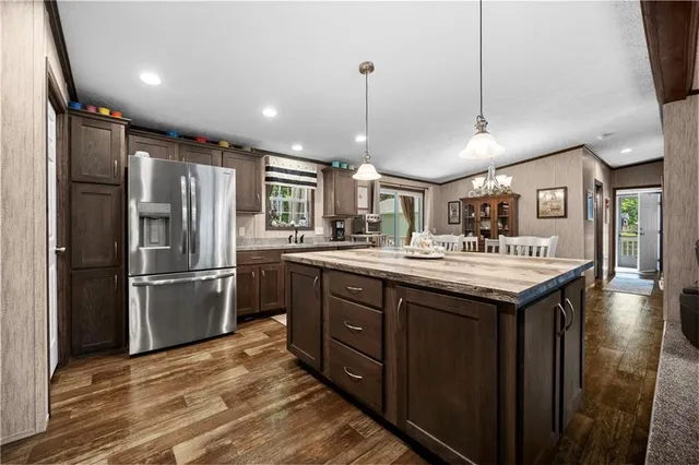 a kitchen with stainless steel appliances granite countertop a sink a stove and a refrigerator