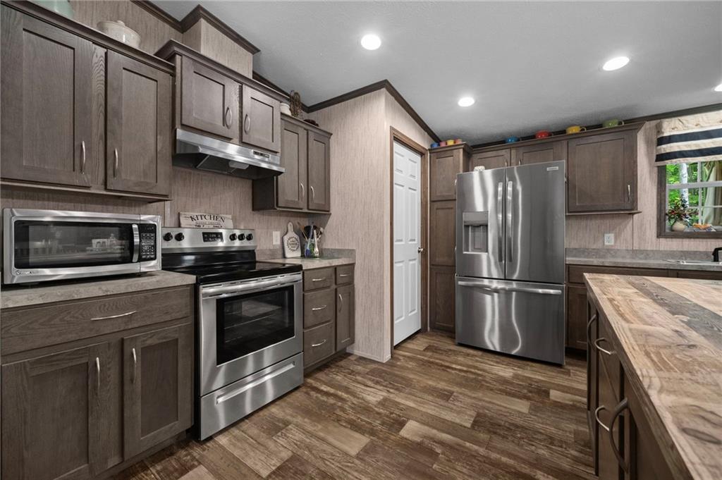 73 South Summit Road, Unit 510 Greenville, PA 16125 - Photo 9 of 33 a kitchen with stainless steel appliances granite countertop a refrigerator a stove a sink and a microwave