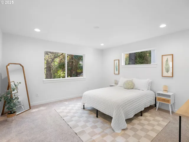 a bedroom with a bed and a potted plant
