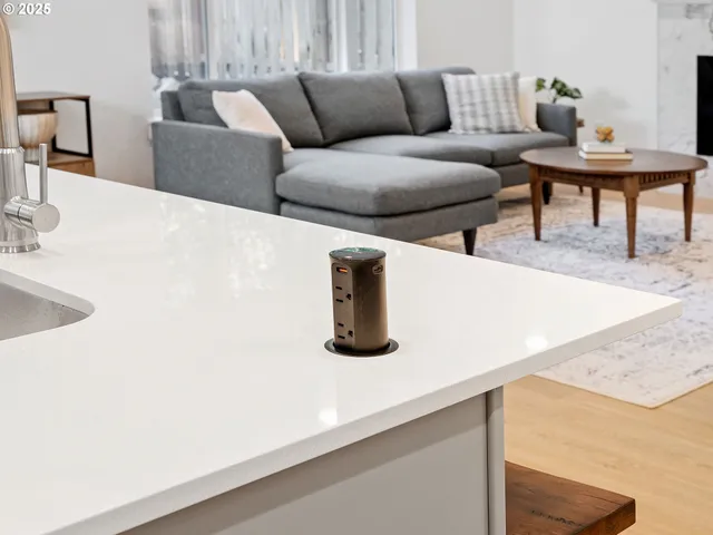 a view of a chair and table in backyard of the house