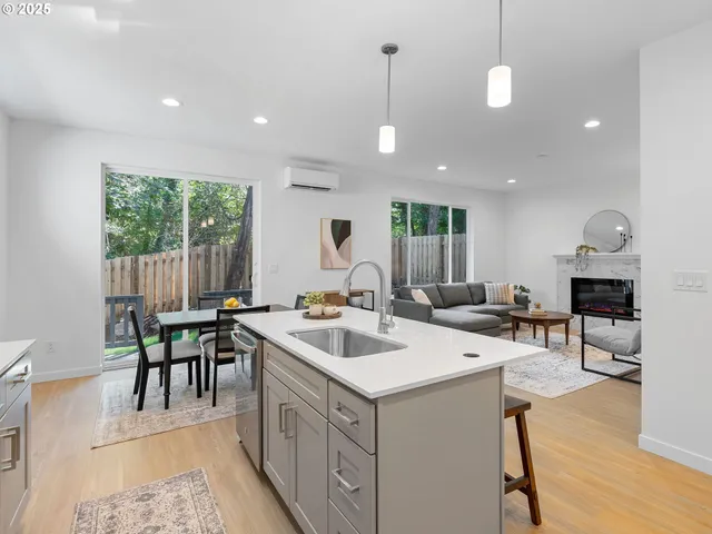 a view of kitchen with a sink dining table and chairs