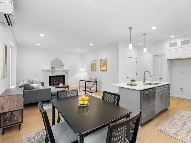 a kitchen with a sink a stove a refrigerator and white cabinets