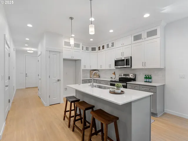 a view of a dining room with a table and chairs