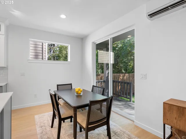 a kitchen with stainless steel appliances granite countertop a dining table chairs stove refrigerator and cabinets