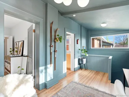 a bedroom with a bed and a large mirror