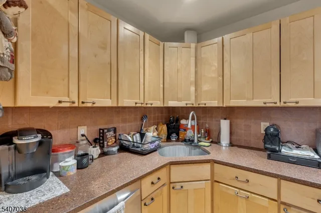 a kitchen with stainless steel appliances granite countertop a sink a stove and cabinets