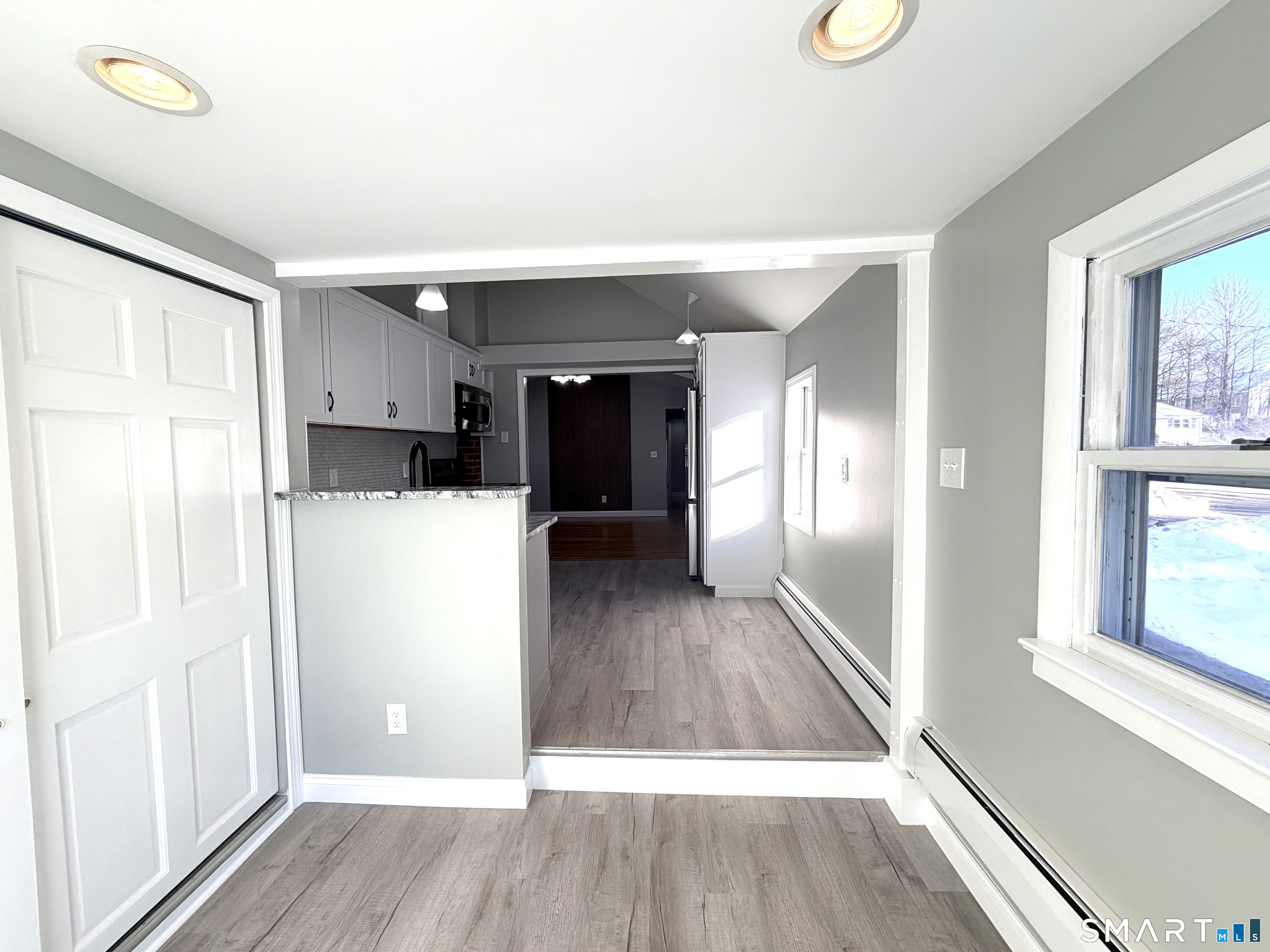 141 Starr Hill Road Groton, CT 06340 - Photo 13 of 31 a view of a kitchen with wooden floor and electronic appliances