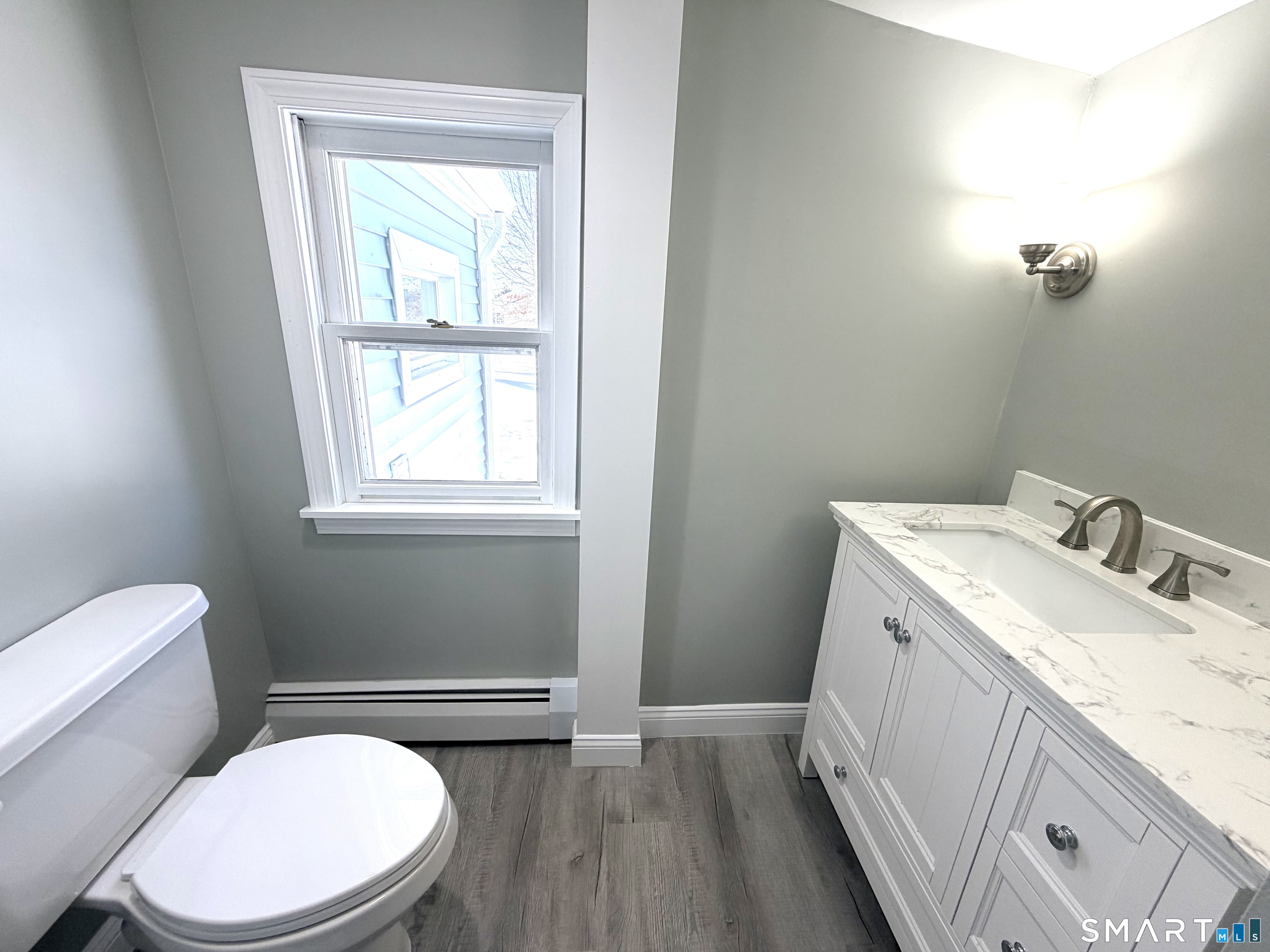 141 Starr Hill Road Groton, CT 06340 - Photo 14 of 31 a bathroom with a granite countertop toilet sink and mirror