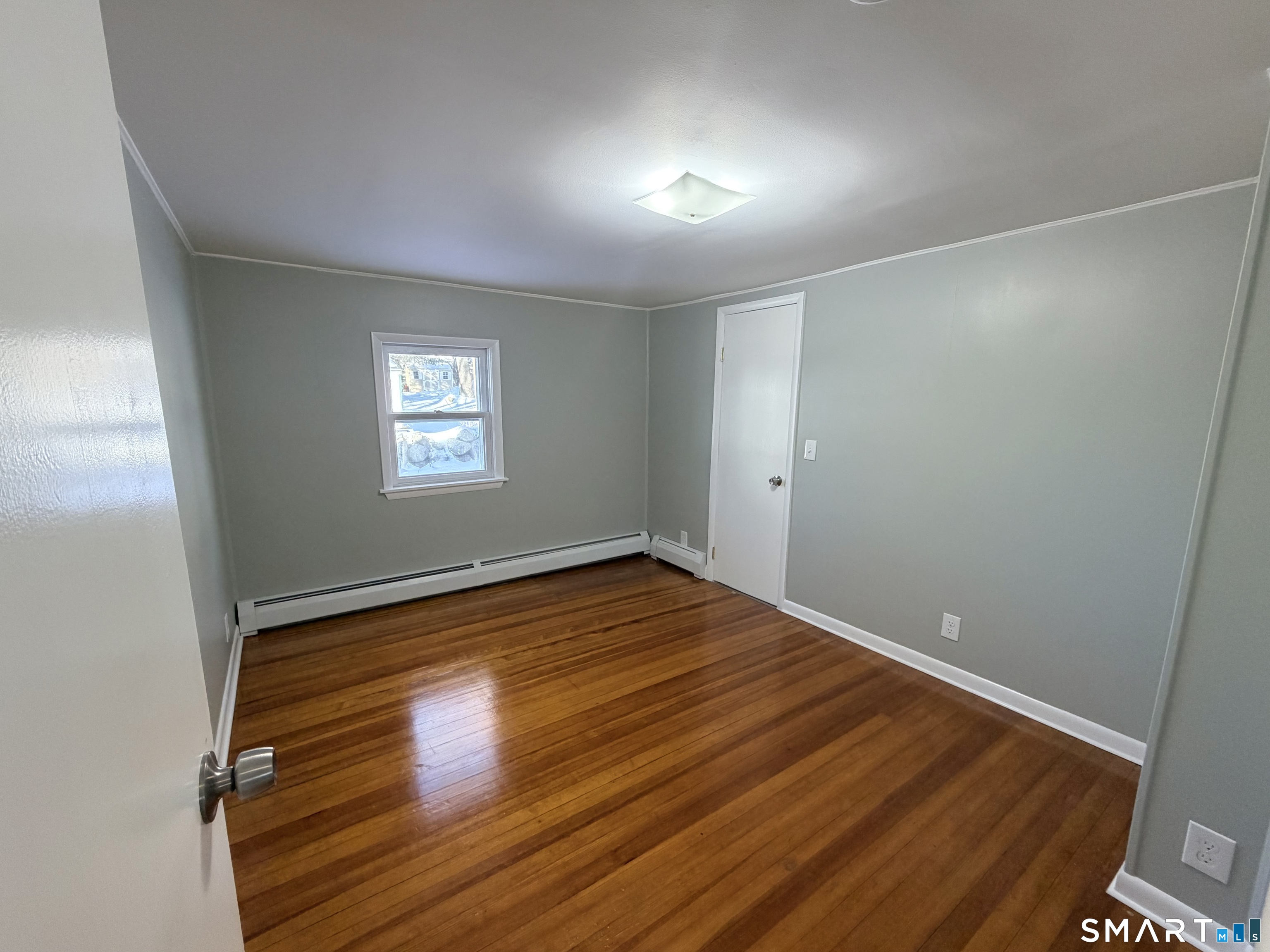 141 Starr Hill Road Groton, CT 06340 - Photo 19 of 31 a view of empty room with window and wooden floor