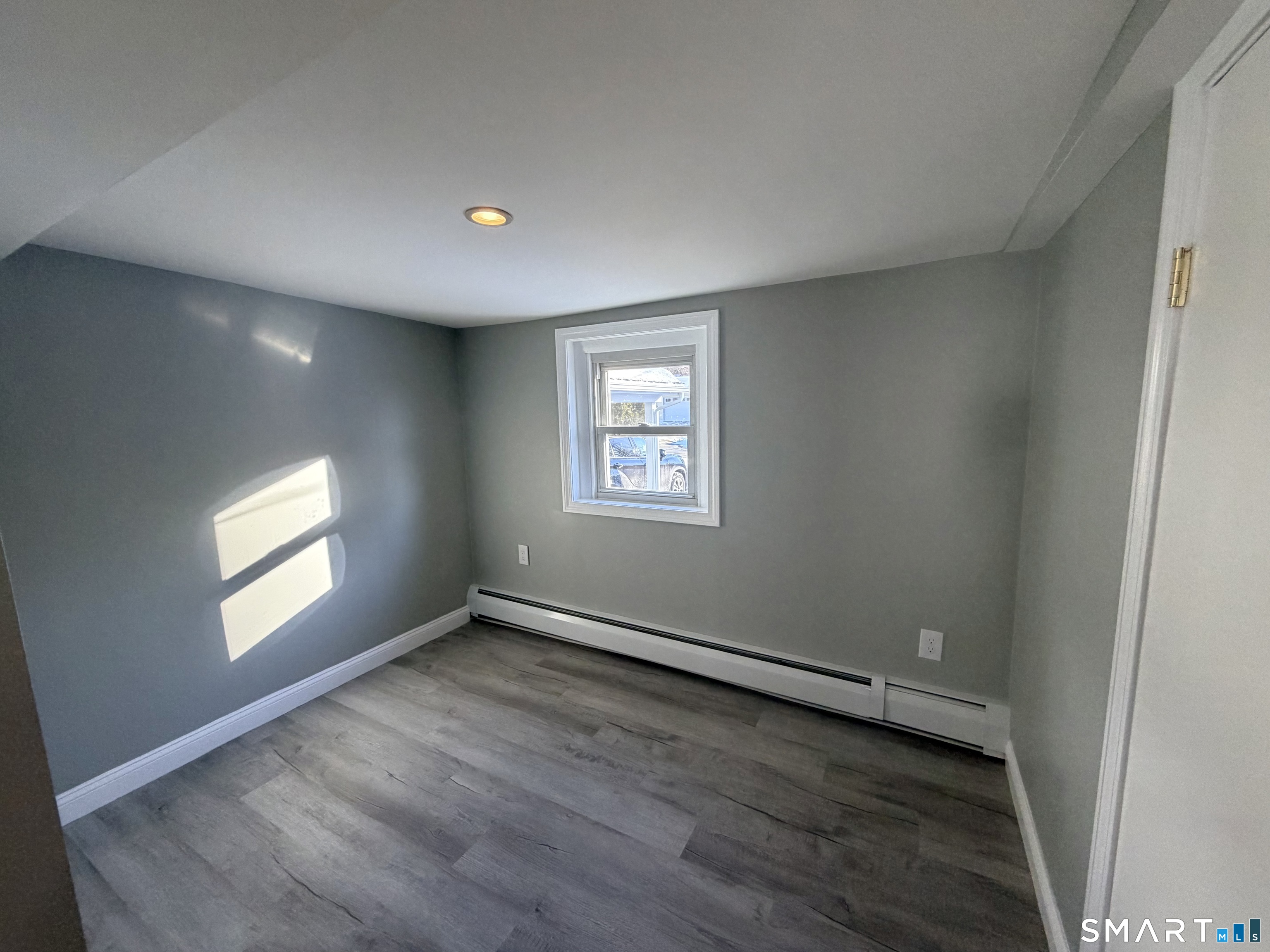 141 Starr Hill Road Groton, CT 06340 - Photo 20 of 31 an empty room with wooden floor and windows