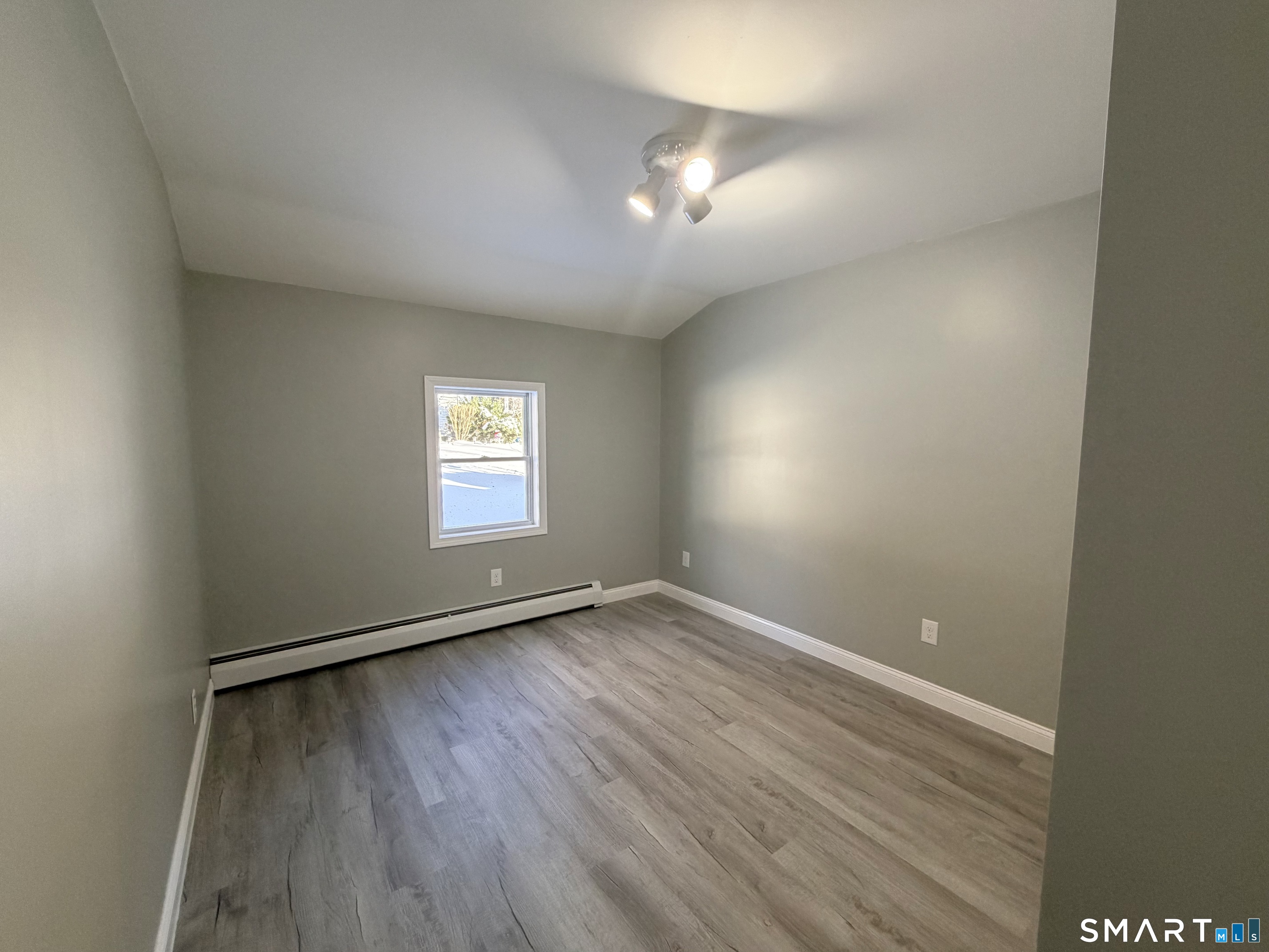 141 Starr Hill Road Groton, CT 06340 - Photo 23 of 31 an empty room with wooden floor and windows