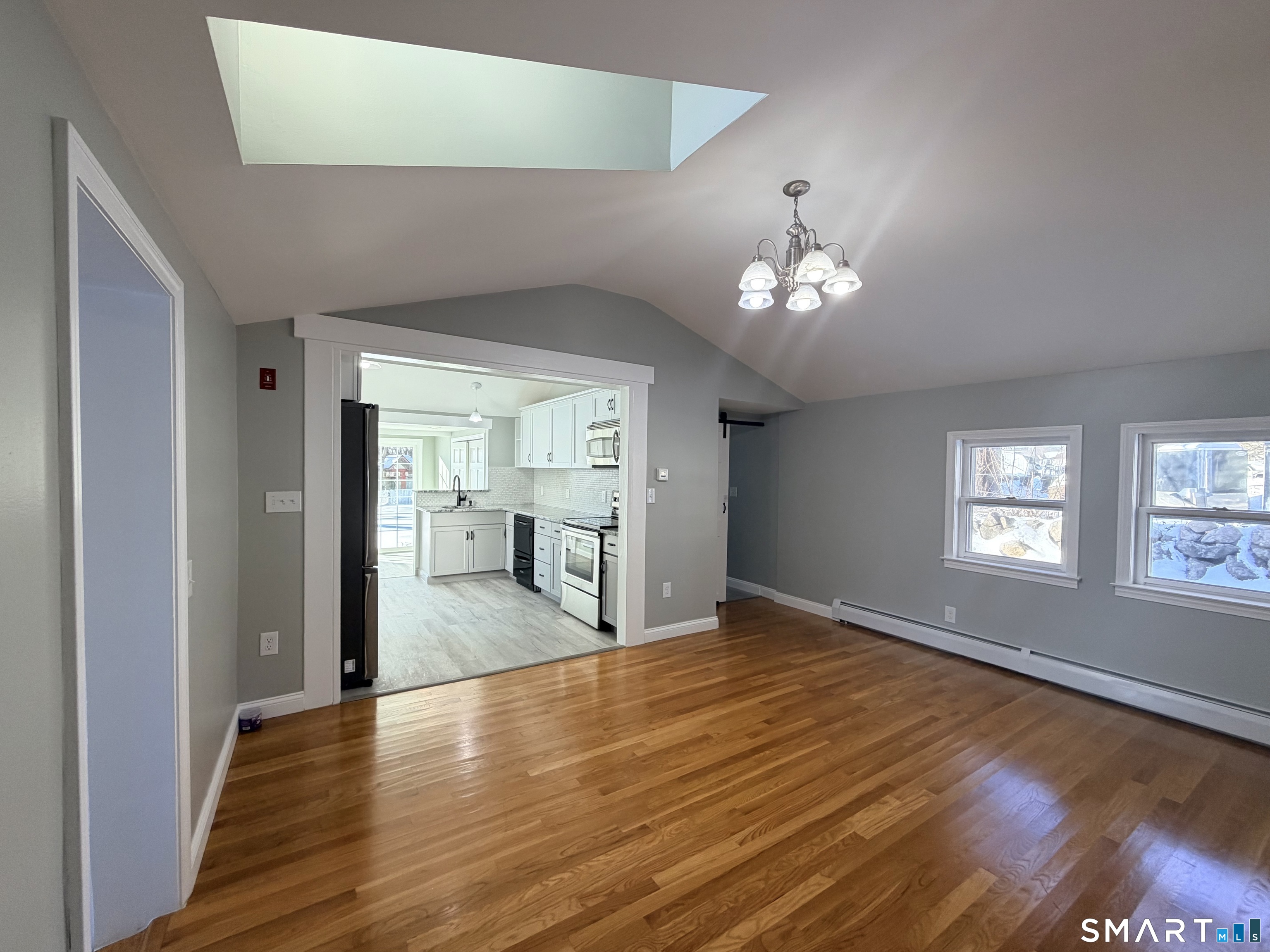 141 Starr Hill Road Groton, CT 06340 - Photo 5 of 31 a view of an empty room with window and wooden floor