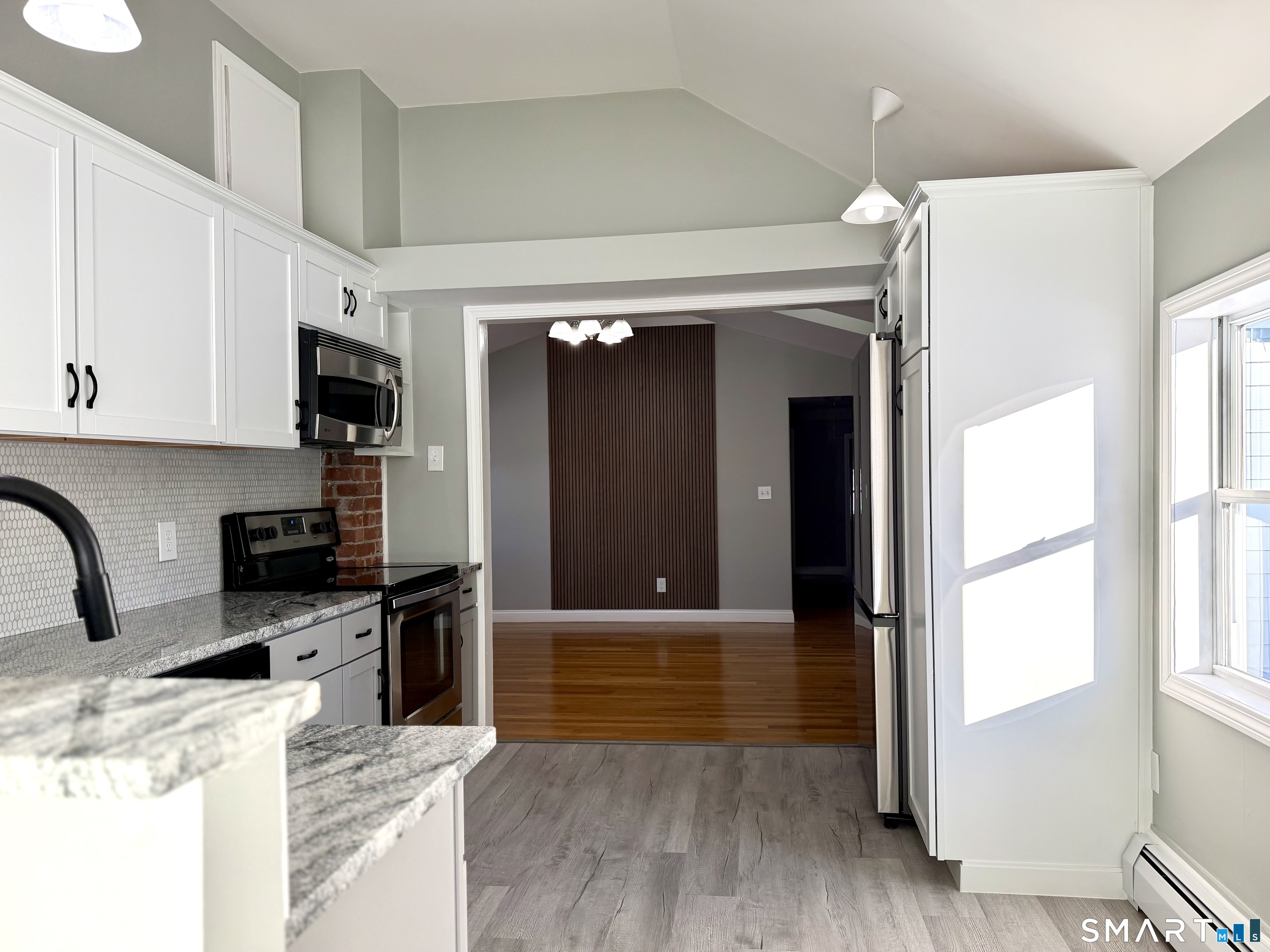 141 Starr Hill Road Groton, CT 06340 - Photo 9 of 31 a kitchen with stainless steel appliances granite countertop a stove and a refrigerator
