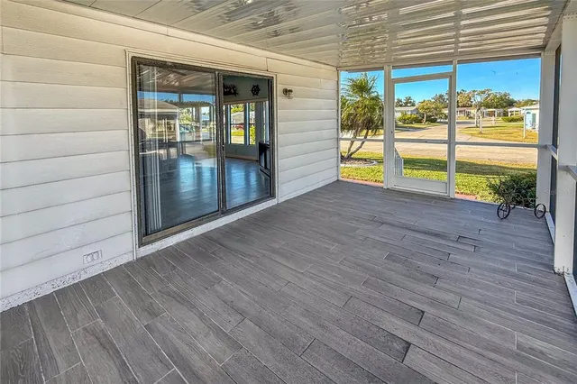 a view of a porch with wooden floor