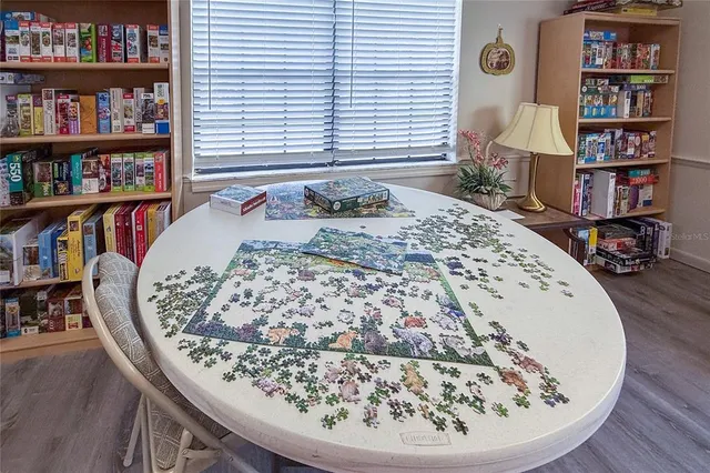 a bed sitting in a bedroom next to a book shelf