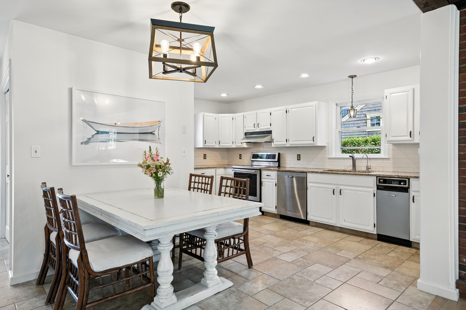 2 The Grove Nantucket, MA 02554 - Photo 11 of 33 a kitchen with a dining table chairs appliances and cabinets