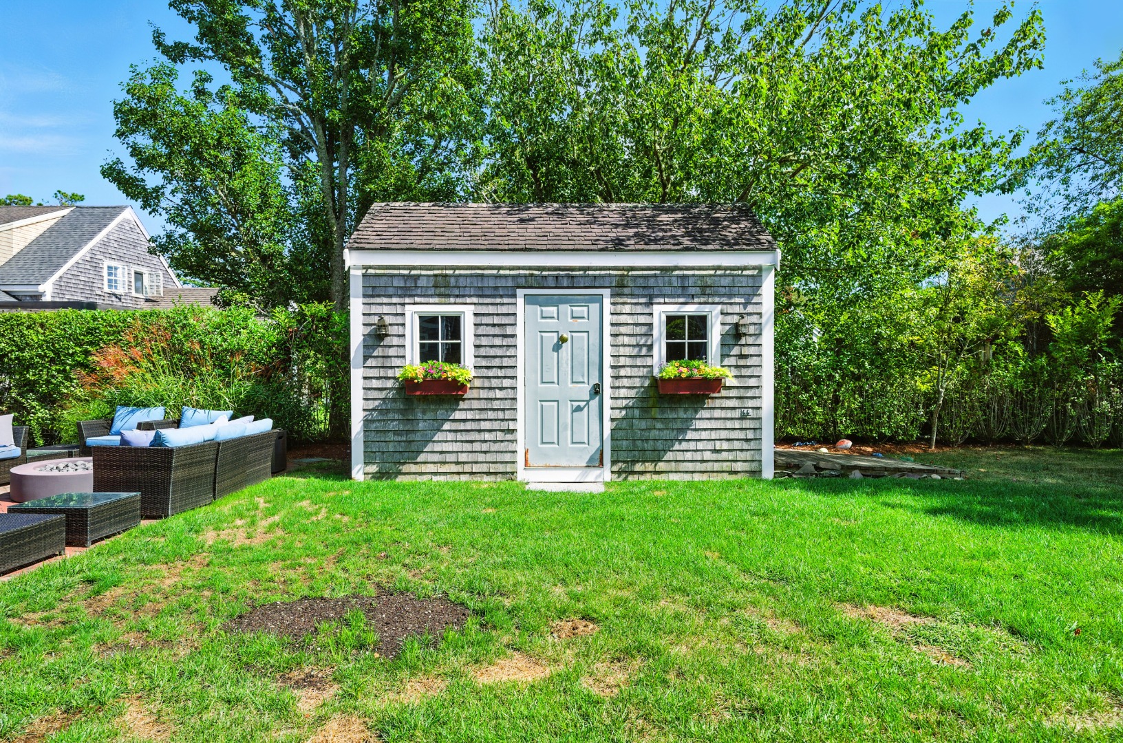 2 The Grove Nantucket, MA 02554 - Photo 23 of 33 a backyard of a house with table and chairs
