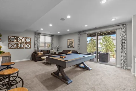 a living room with furniture a rug and a large window