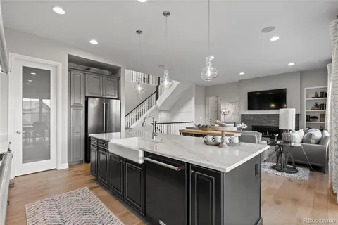 a kitchen with a stove a refrigerator and a sink