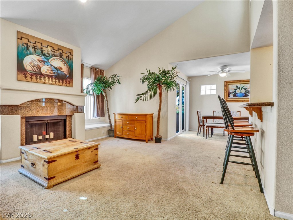 3145 East Flamingo Road, Unit 2129 Las Vegas, NV 89121 - Photo 4 of 43 A spacious living area features a fireplace and a seamless flow into the dining space, ideal for entertaining.