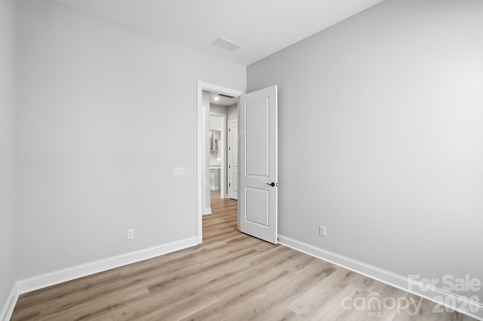 1035 Rabbit Hl Lane Monroe, NC 28110 - Photo 25 of 39 a view of an empty room with wooden floor