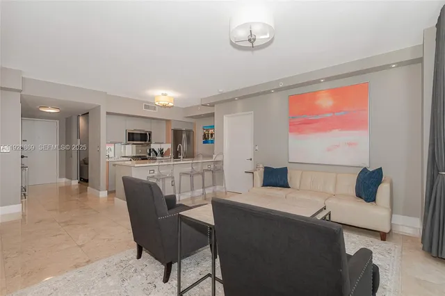 a view of a livingroom with furniture and a window