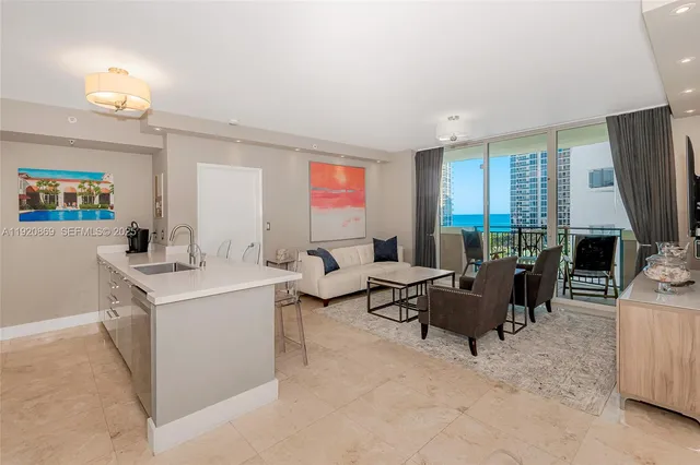 a living room with furniture a large window and flat screen tv