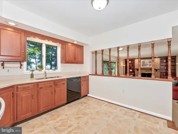 a large kitchen with kitchen island granite countertop a large window