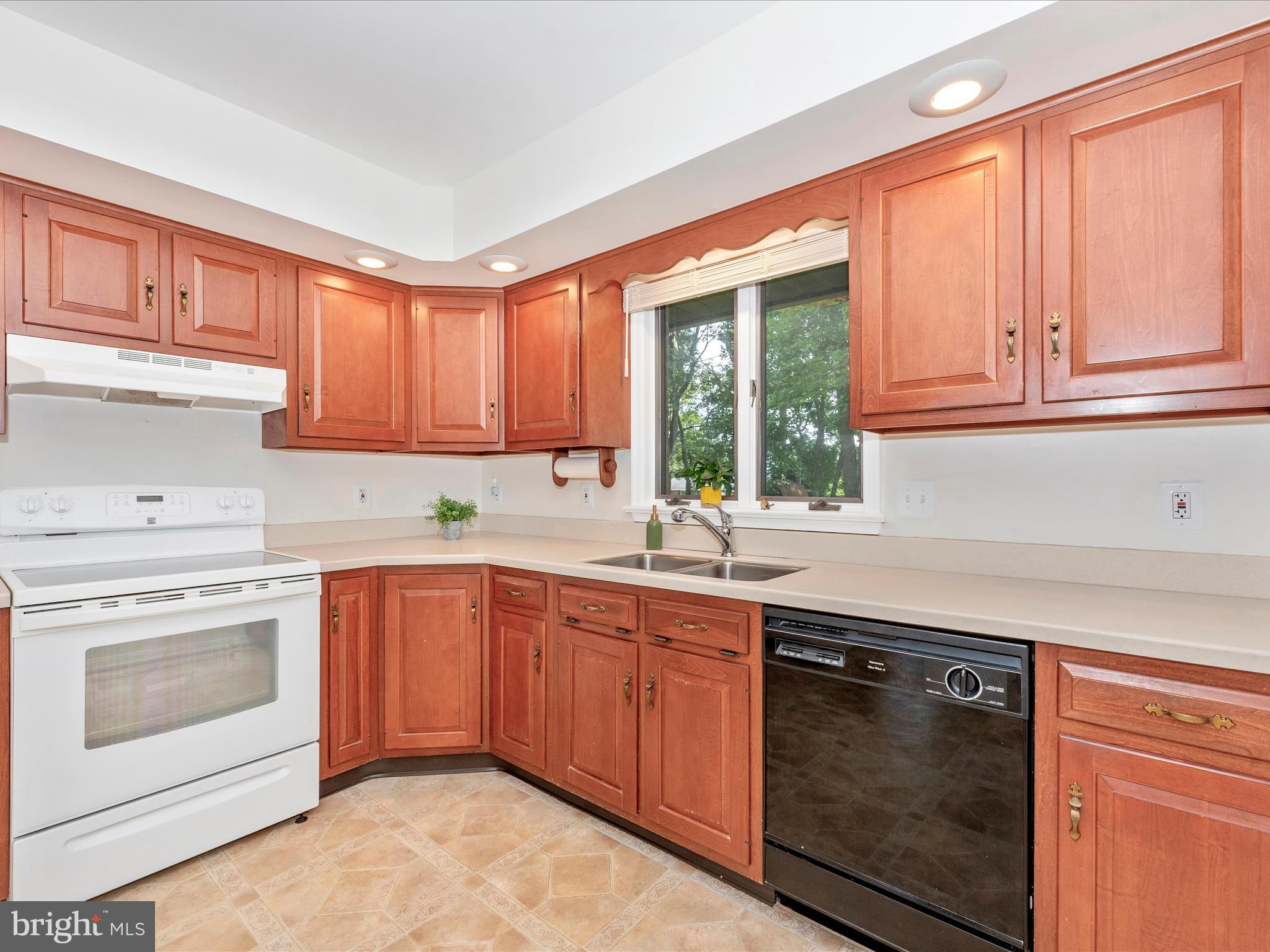 5018 Camelback Lane Frederick, MD 21703 - Photo 14 of 41 a kitchen with stainless steel appliances granite countertop a sink stove and cabinets