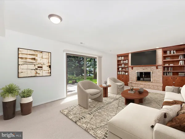 a living room with furniture potted plant and a fireplace
