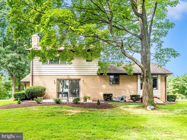 a front view of a house with a garden and plants