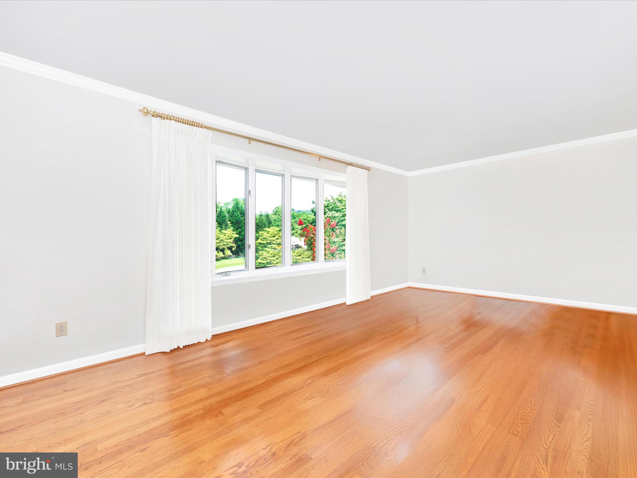 5018 Camelback Lane Frederick, MD 21703 - Photo 5 of 41 an empty room with wooden floor and windows