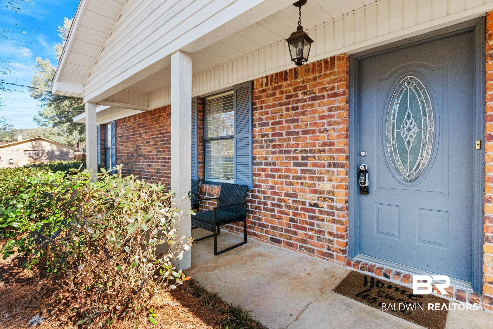 5366 Scanlan Way West Satsuma, AL 36572 - Photo 3 of 43 View of exterior entry featuring a porch and brick siding