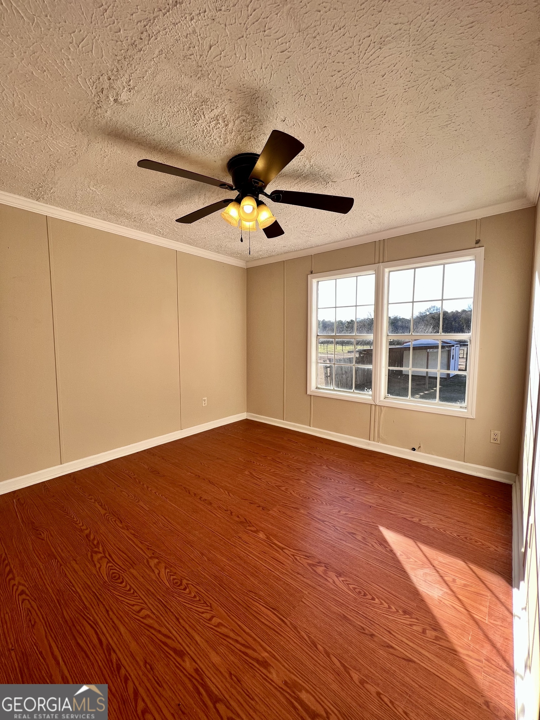 103 Henderson Springs Road Elko, GA 31025 - Photo 18 of 33 a view of an empty room with wooden floor and a window