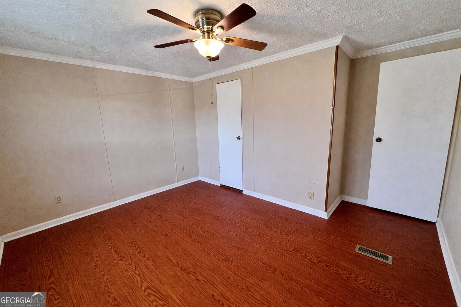 103 Henderson Springs Road Elko, GA 31025 - Photo 19 of 33 an empty room with wooden floor and a ceiling fan