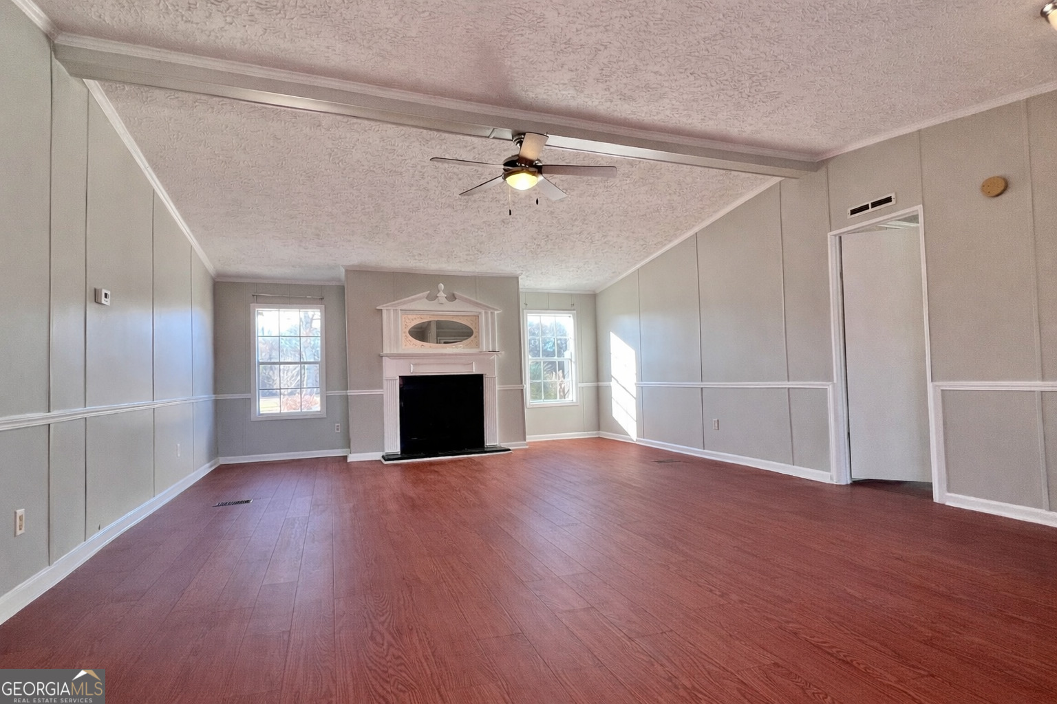 103 Henderson Springs Road Elko, GA 31025 - Photo 4 of 33 a view of empty room with wooden floor and fireplace