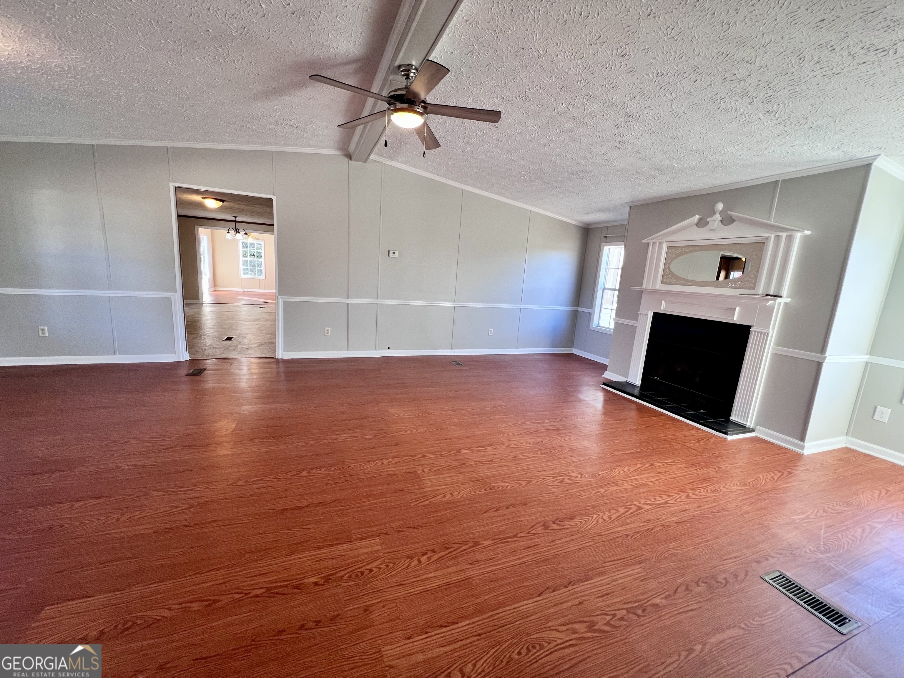 103 Henderson Springs Road Elko, GA 31025 - Photo 5 of 33 an empty room with wooden floor fan and windows